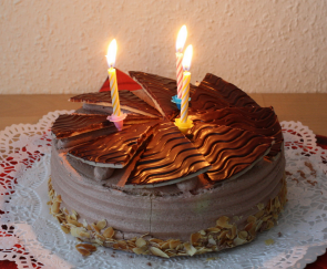 Copyright as noted here: http://en.wikipedia.org/wiki/Birthday_cake#/media/File:Schokoladentorte_Buttercreme_Tulpen_dritter_Geburtstag_001.JPG